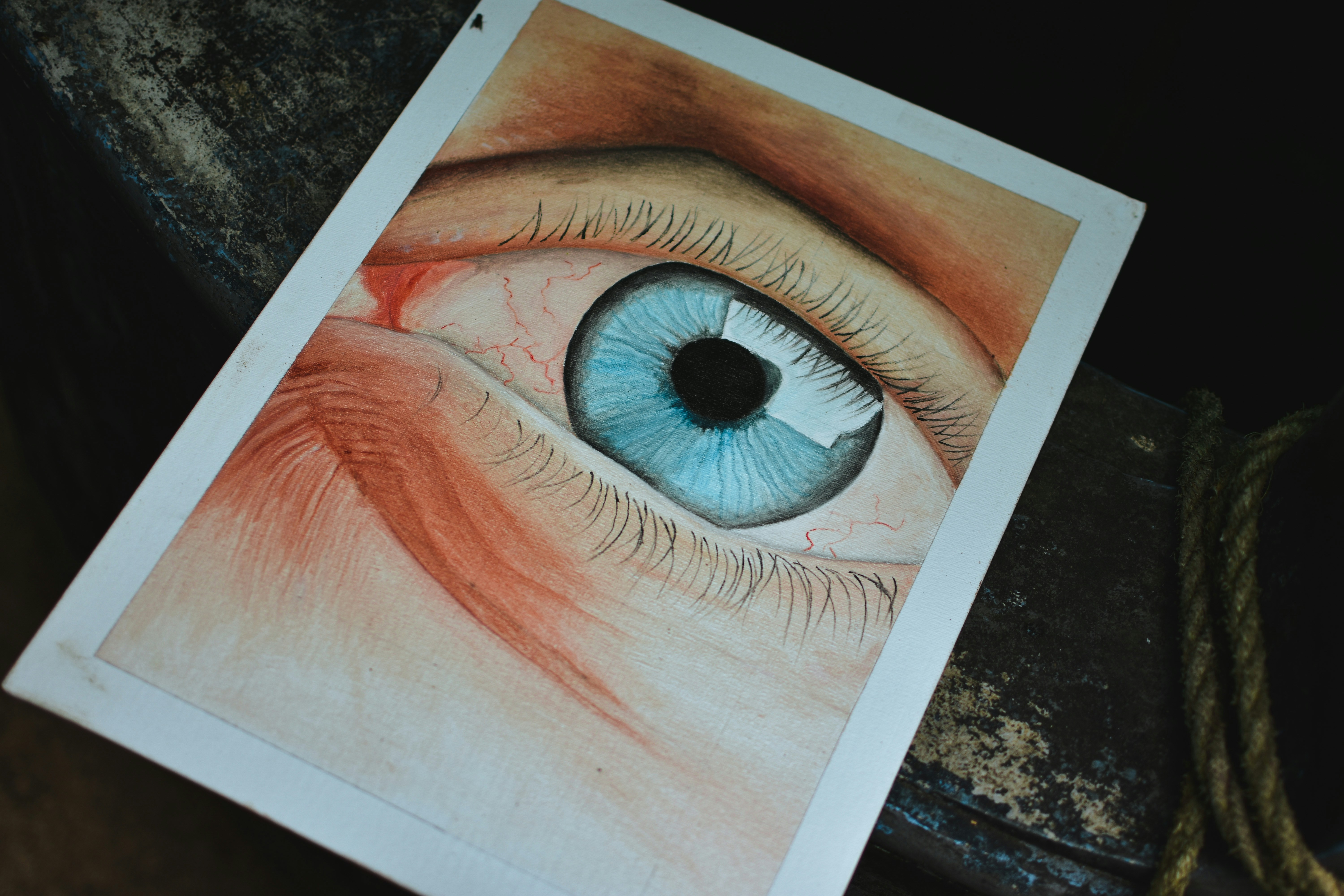 a drawing of a blue eye on a piece of paper