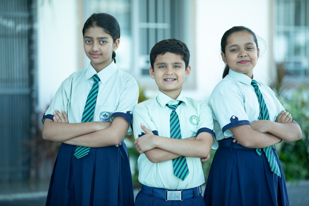 a group of three young girls standing next to each other