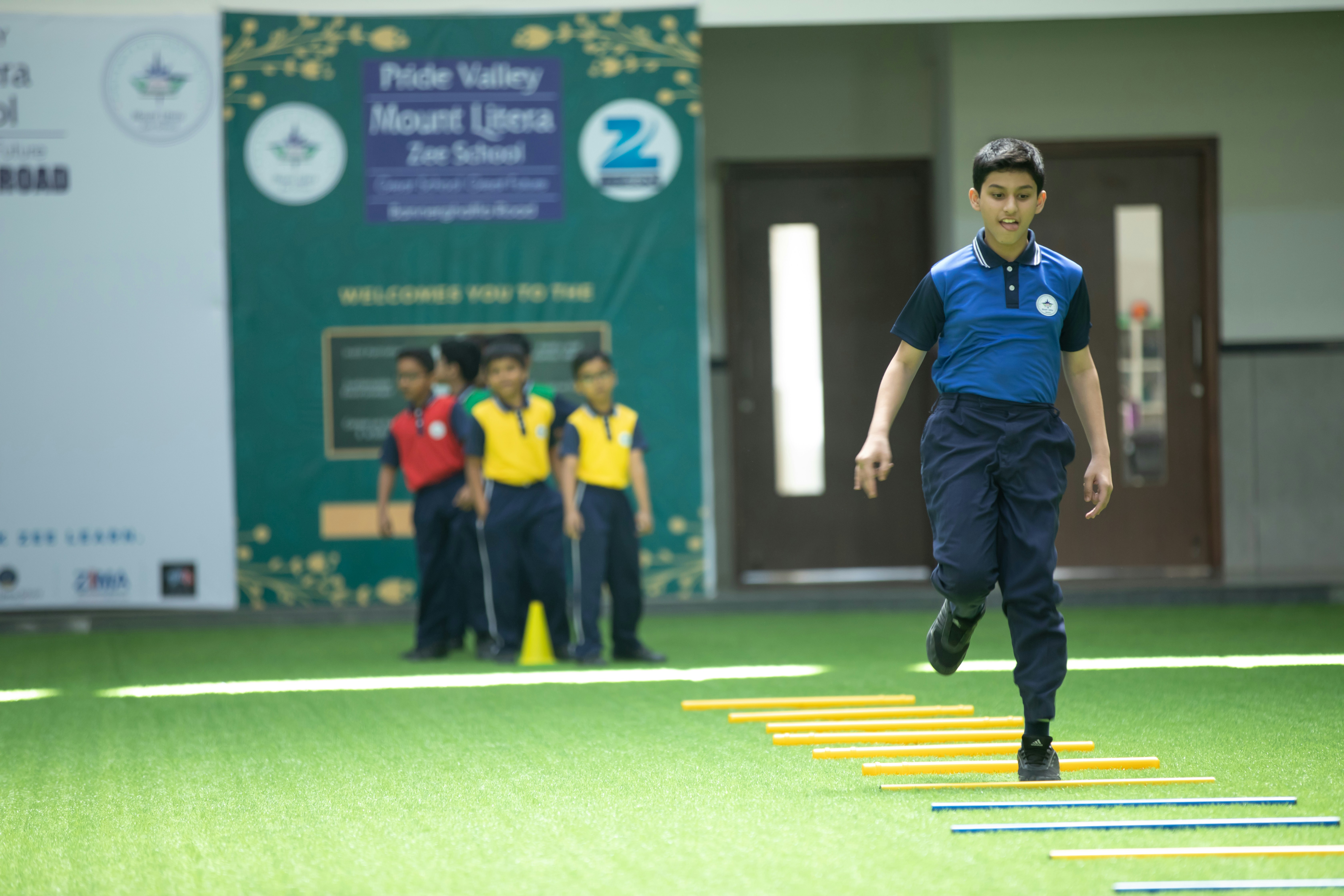 a young boy is running over a set of obstacles