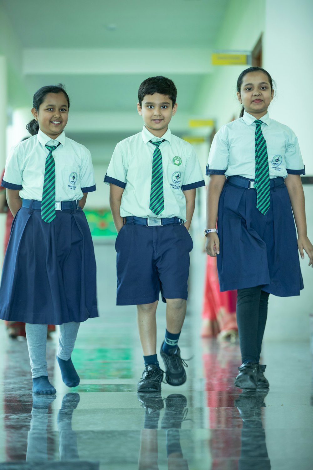 a group of young children walking down a hallway