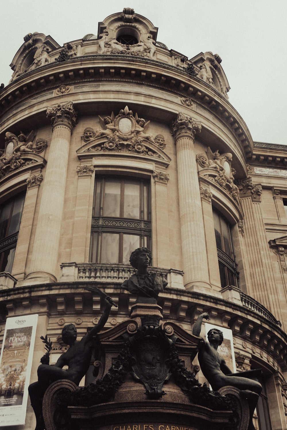 a tall building with a statue of a man on top of it