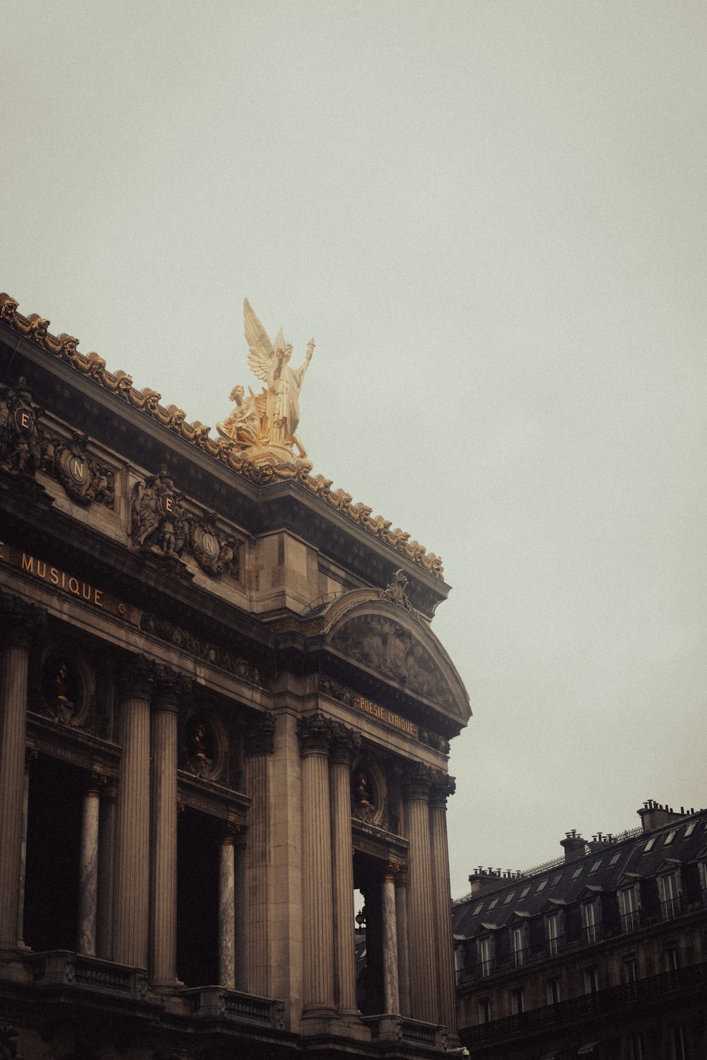 a large building with a statue on top of it