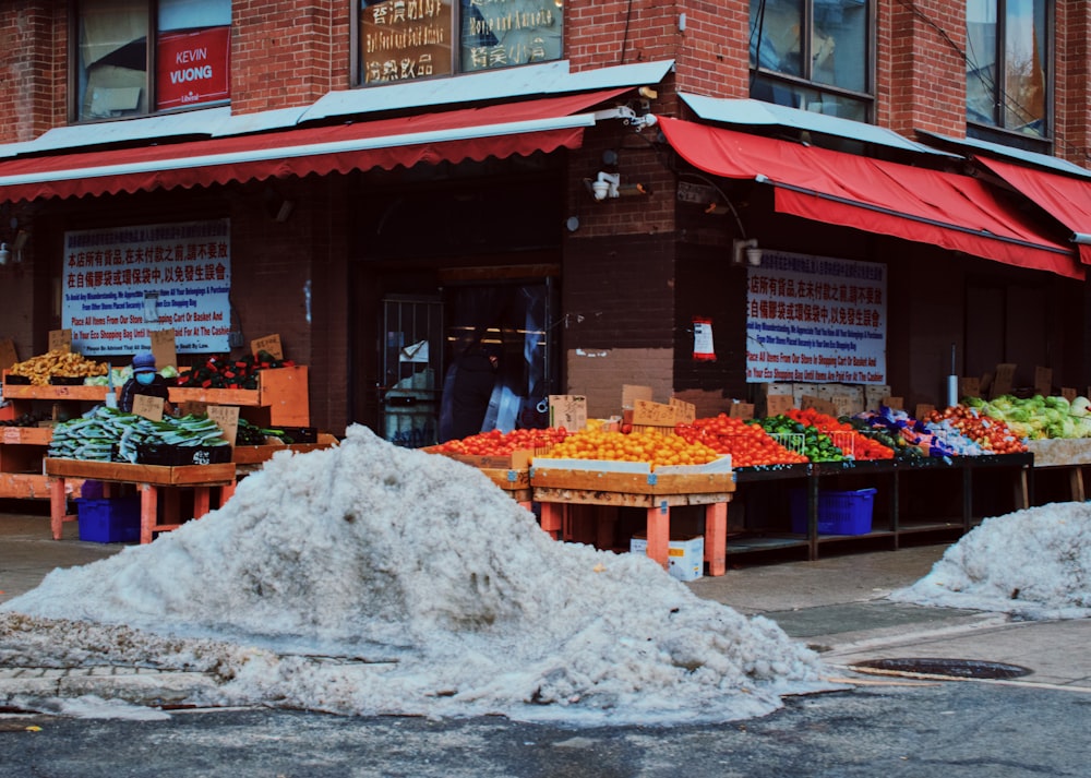 a store front with a pile of snow in front of it