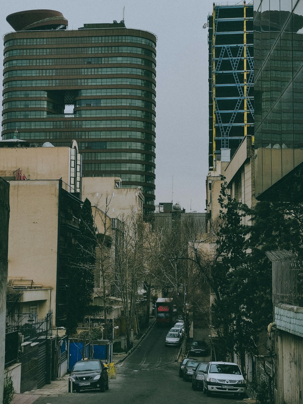 a city street lined with tall buildings and parked cars