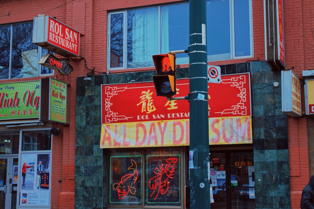 a red brick building with a traffic light in front of it