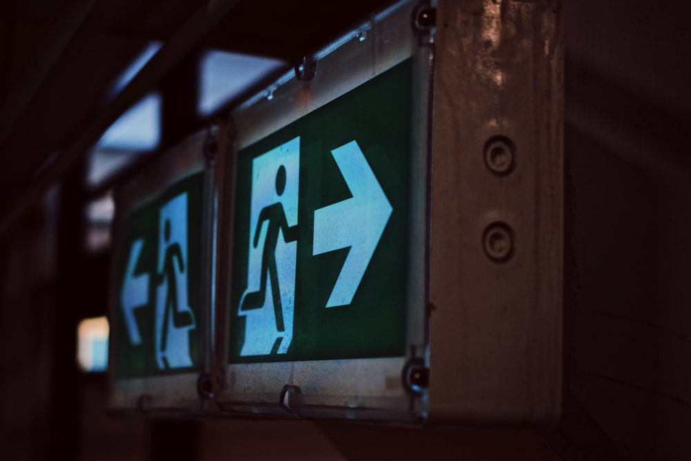 a close up of a green and white sign on a wall