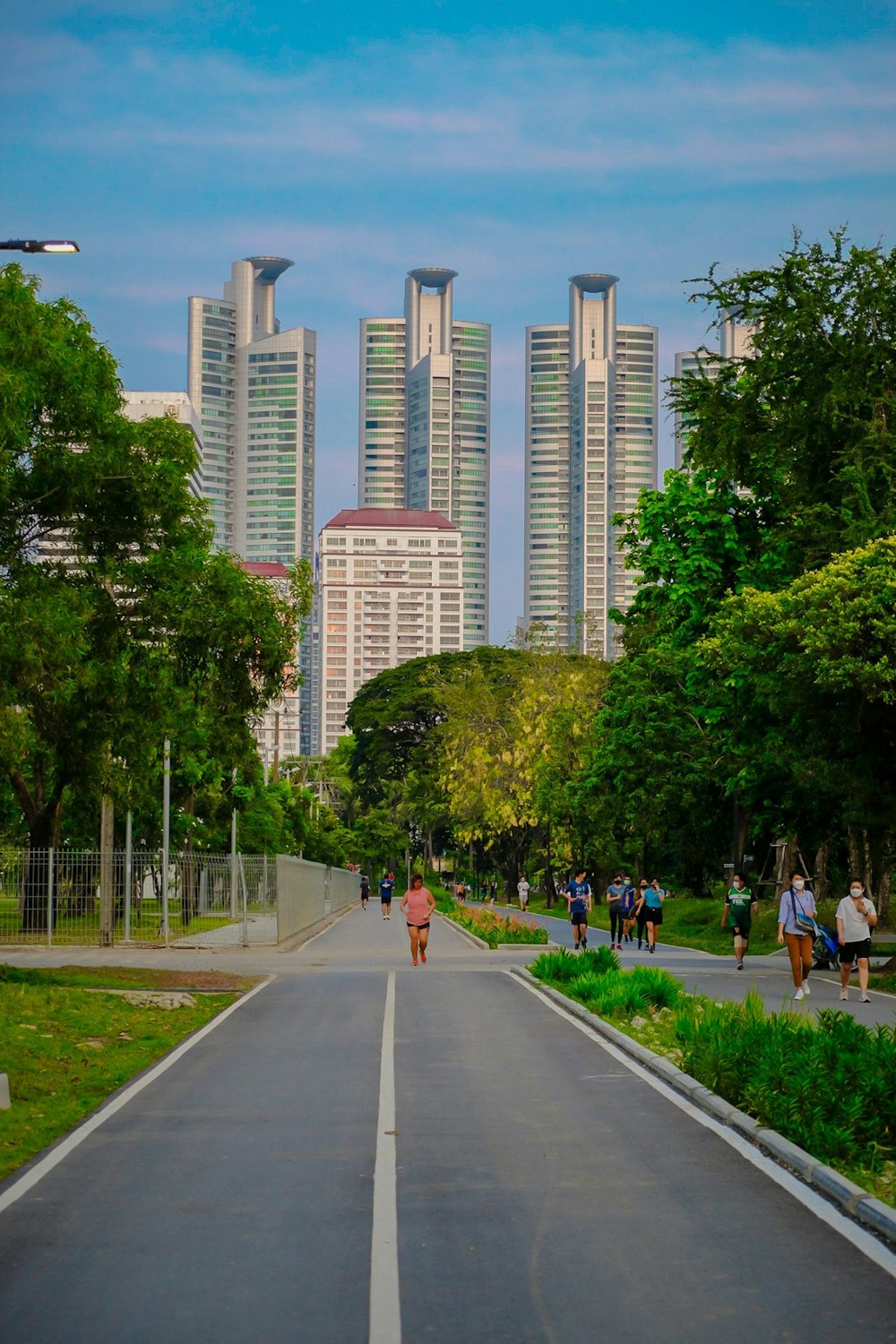 people walking down a street in front of tall buildings