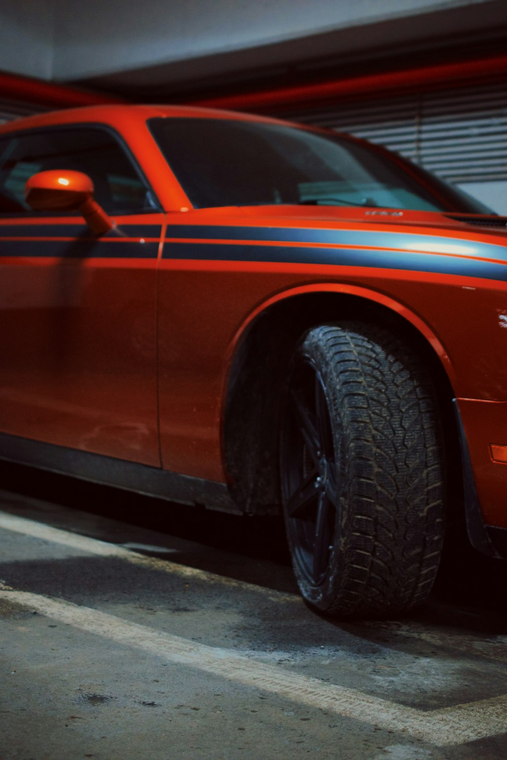 a red car parked in a parking garage