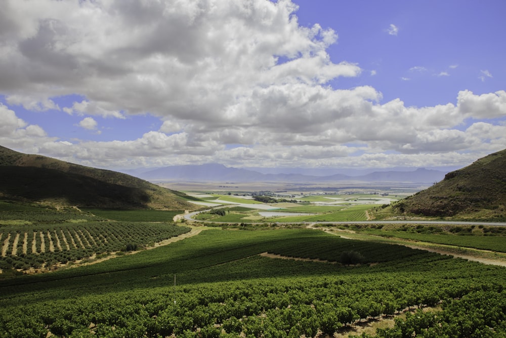 a scenic view of a valley with a road running through it