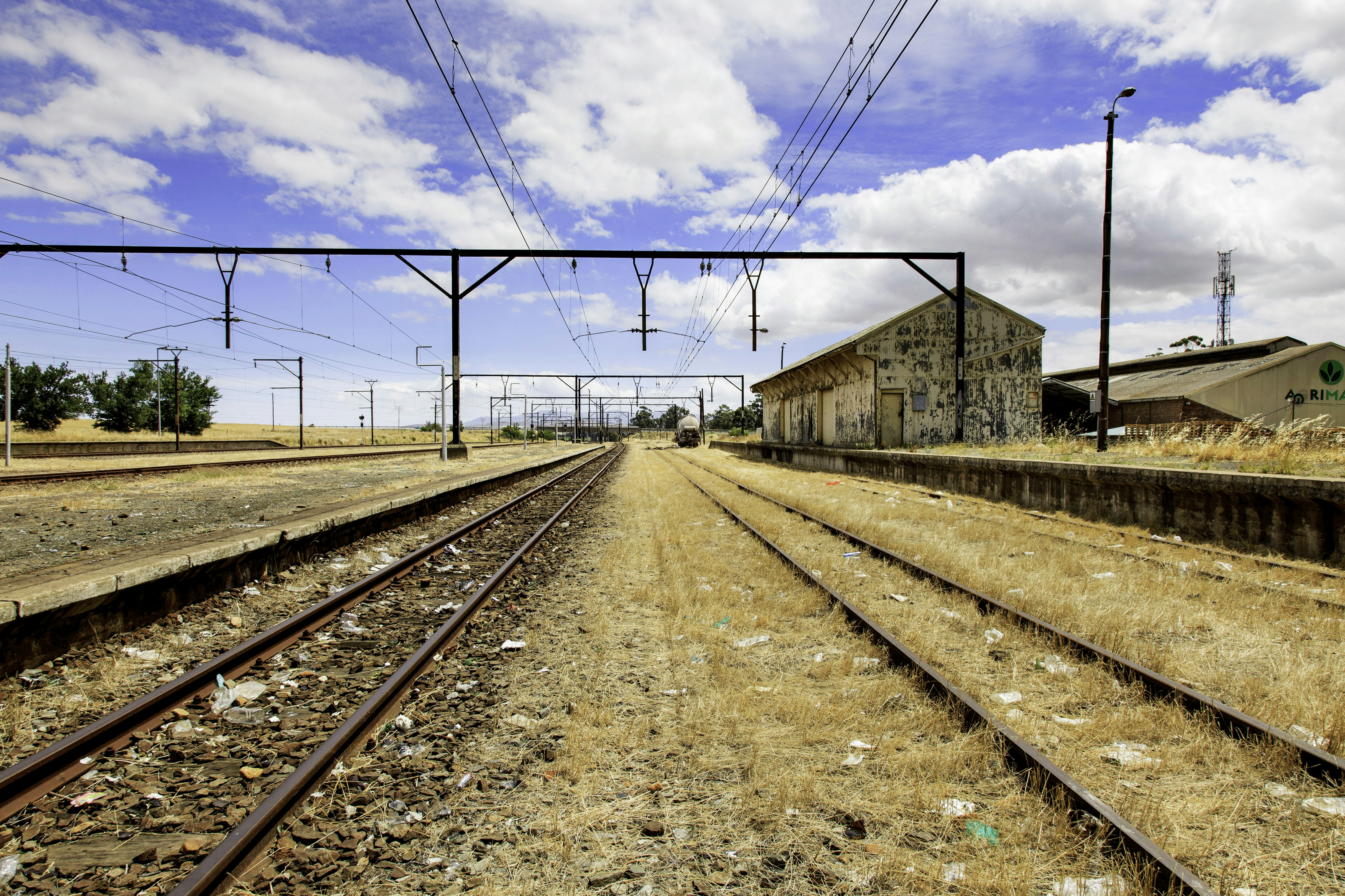 a train track with a building in the background