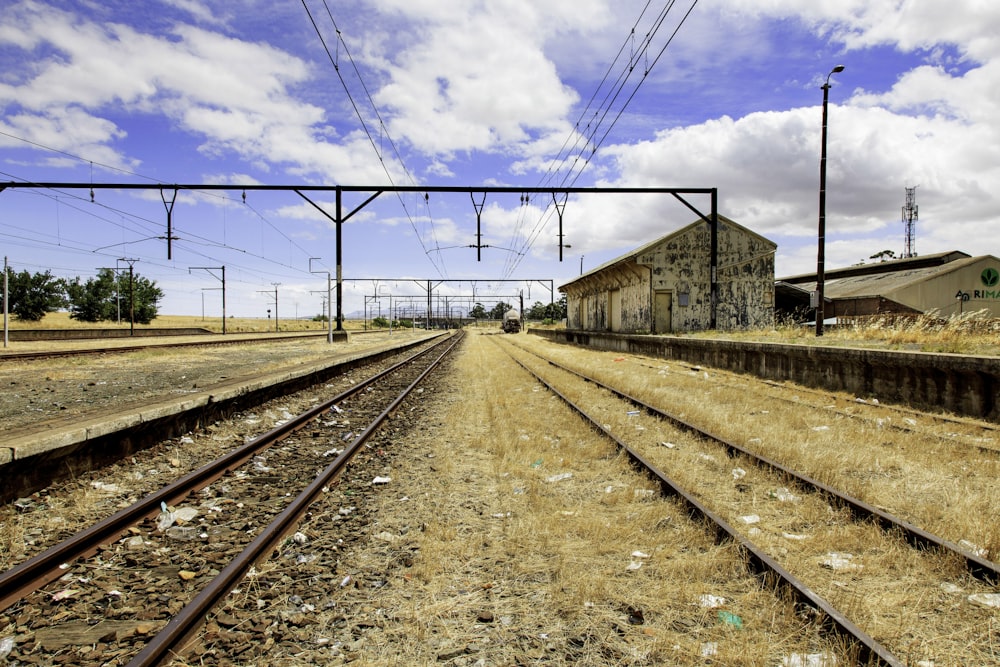 a train track with a building in the background