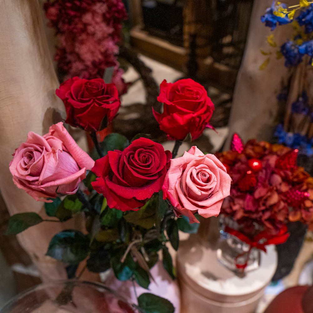 a vase filled with red and pink roses