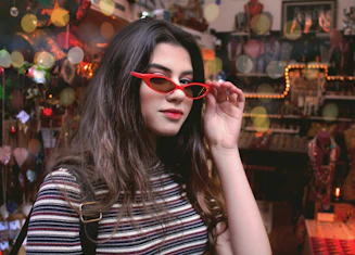 a woman wearing red glasses in a store