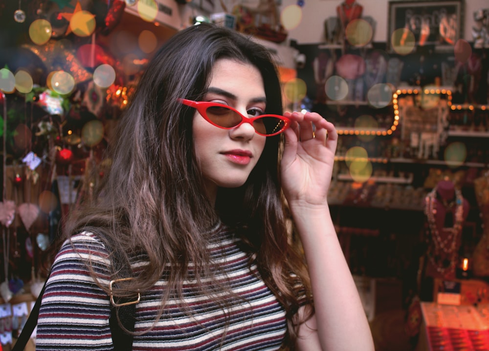 a woman wearing red glasses in a store