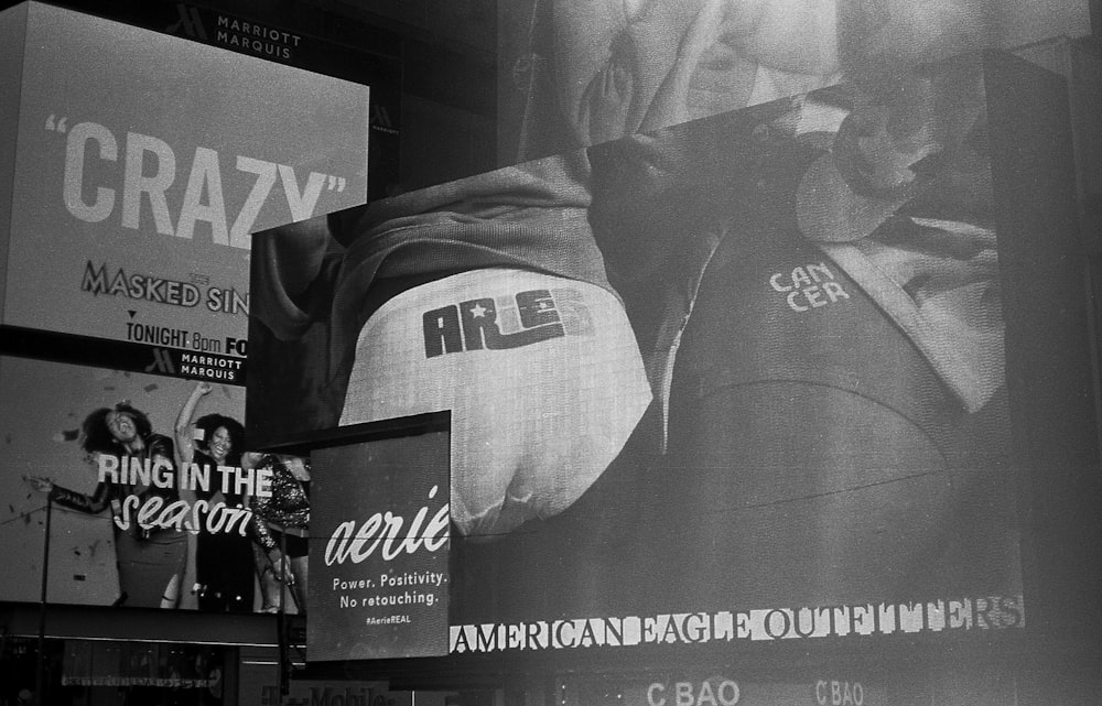 a black and white photo of a billboard on the side of a building