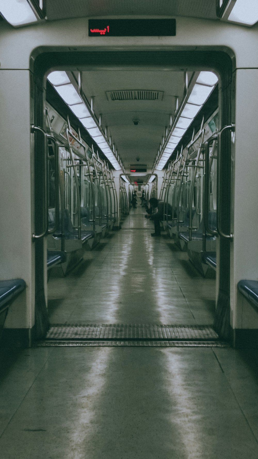 a train station with a row of empty benches