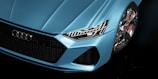 a close up of the front of a blue car