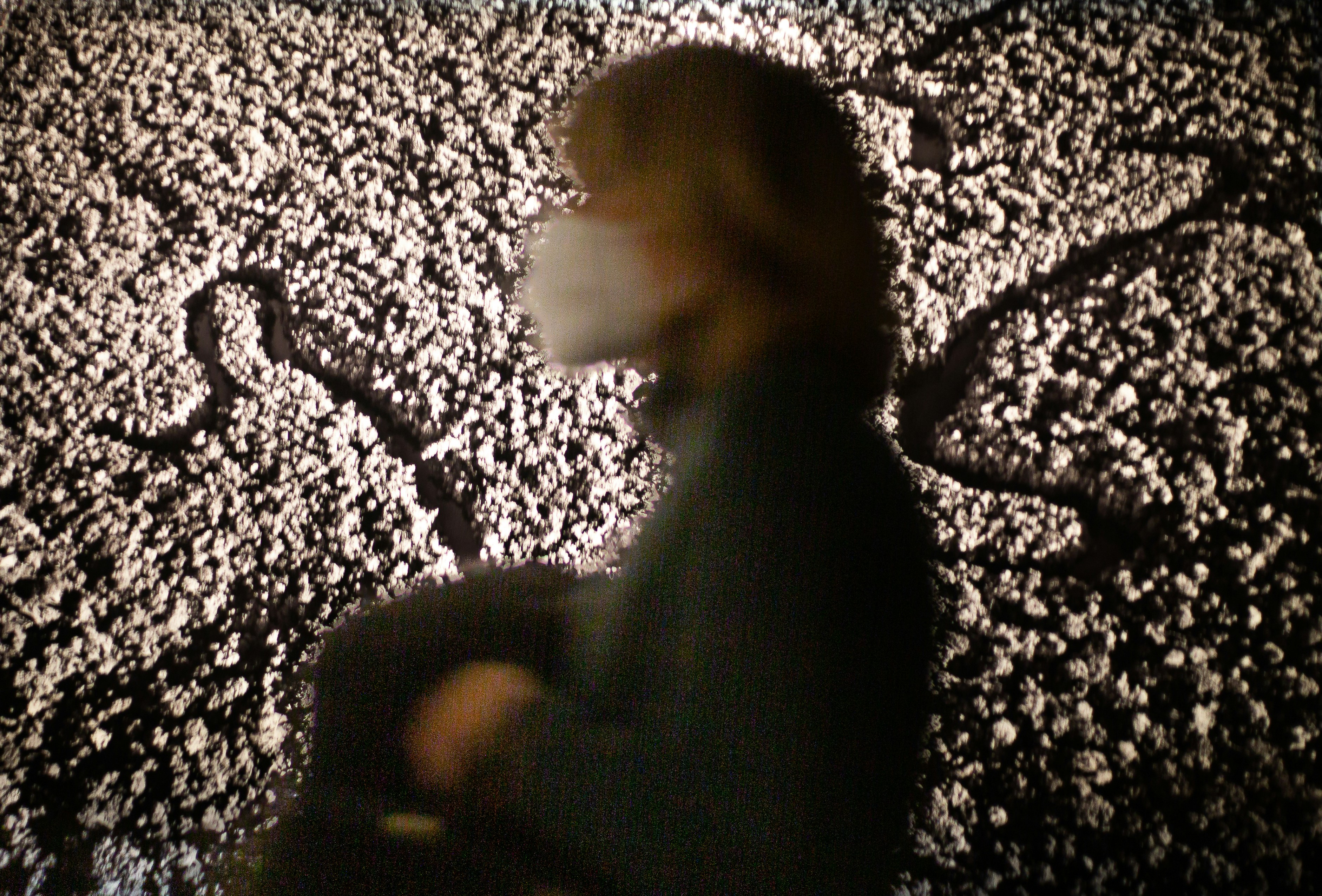 a blurry photo of a person sitting in front of a screen