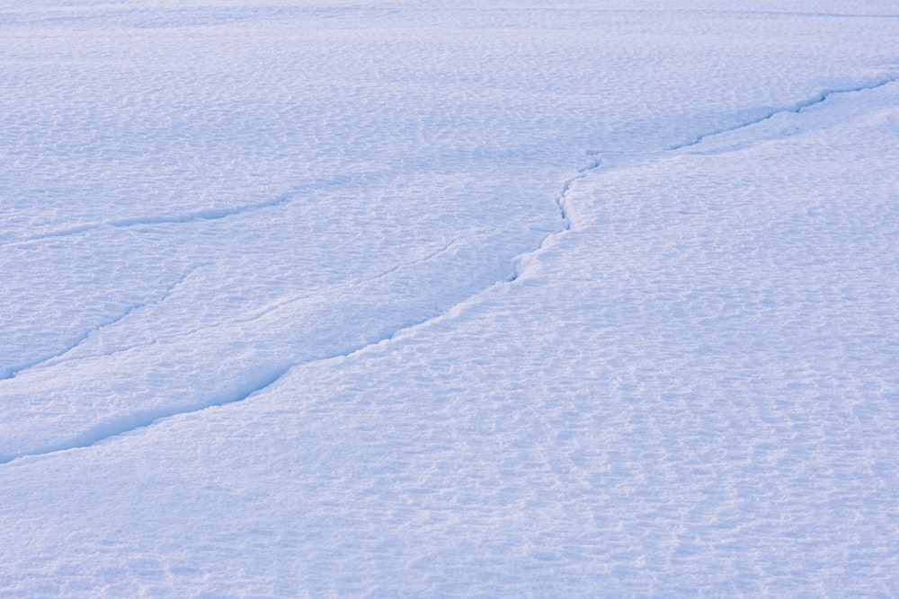 a man riding skis down a snow covered slope