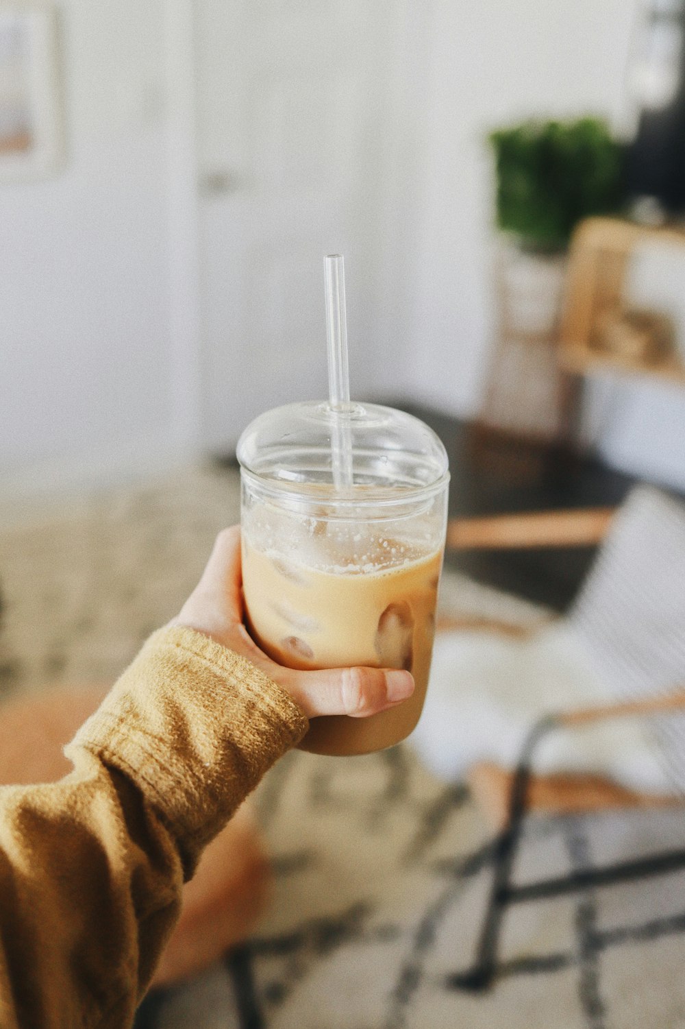 a person holding a cup with a straw in it