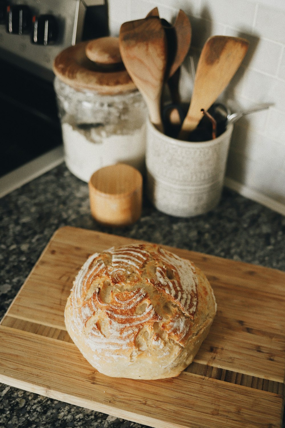 a loaf of bread sitting on top of a wooden cutting board