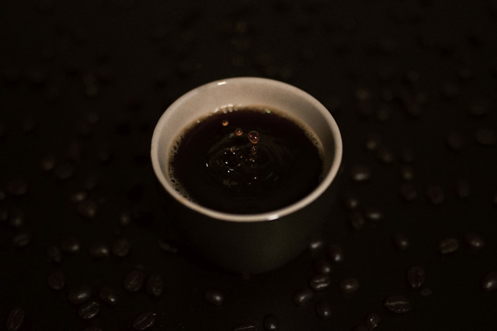 a cup of coffee sitting on top of a table