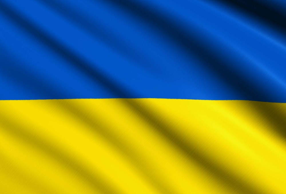 the flag of ukraine is waving in the wind