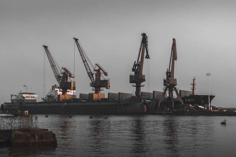 a large ship in the water with cranes on it
