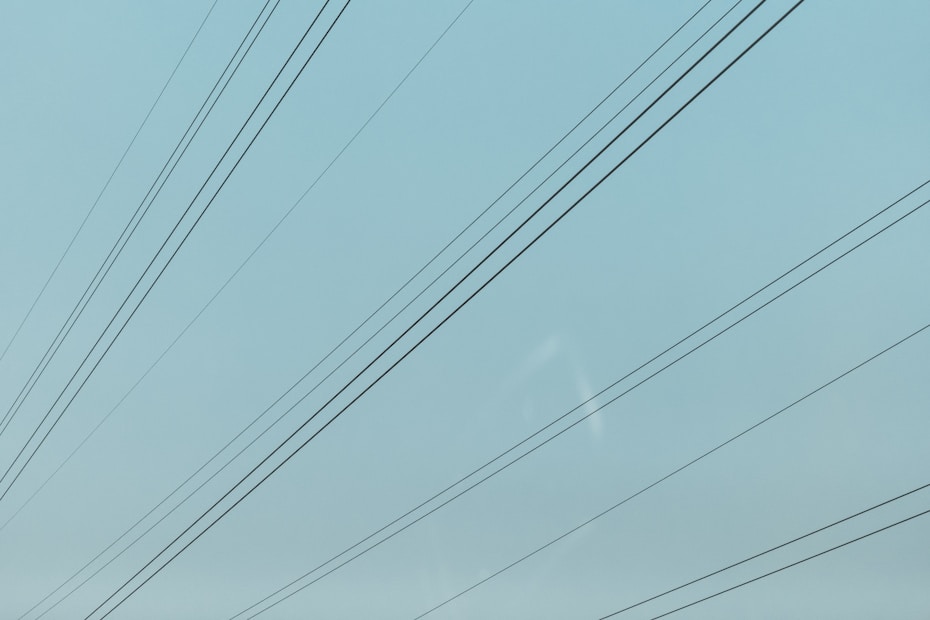 a blue sky with power lines in the foreground