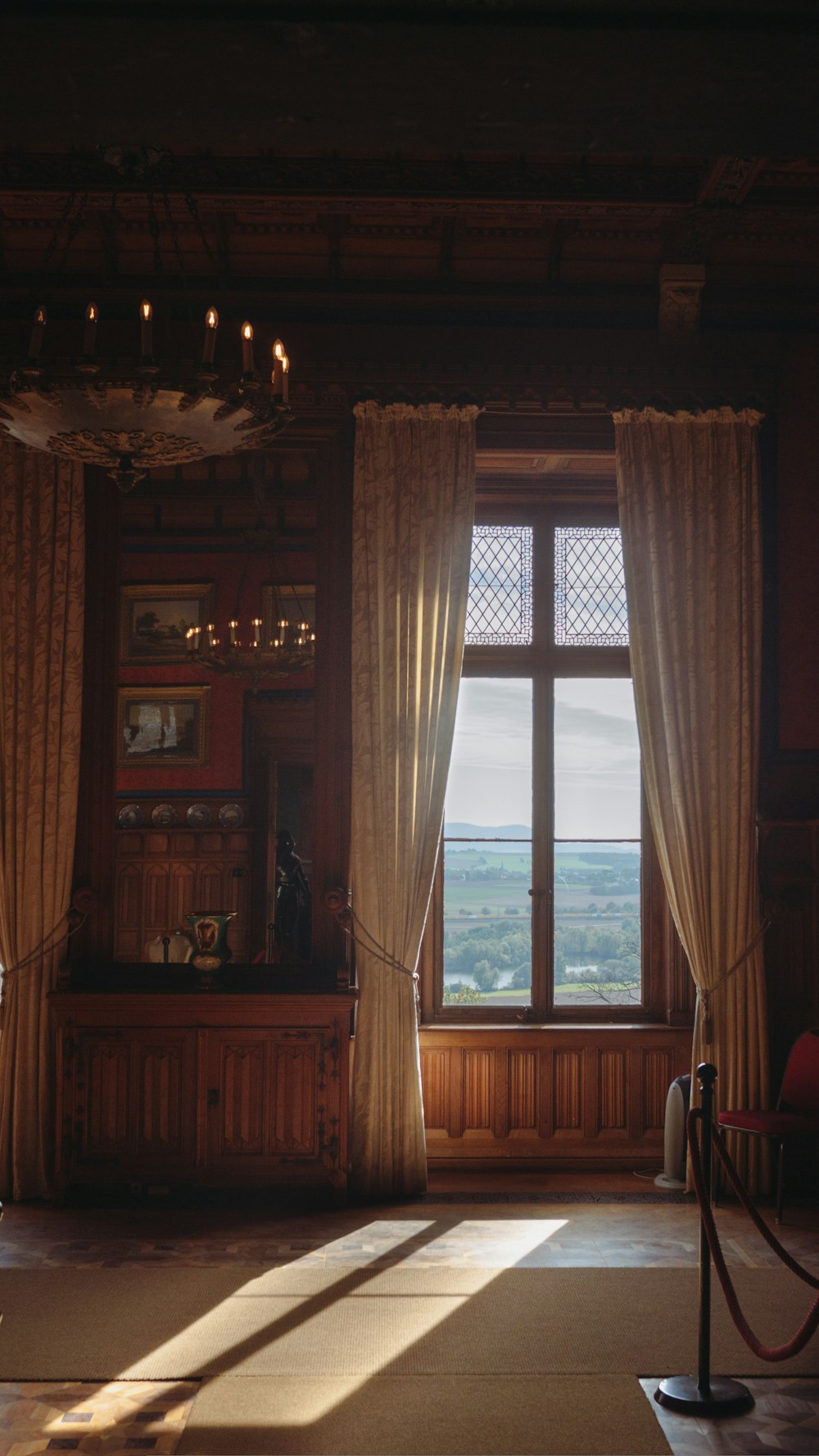 a large room with a large window and curtains