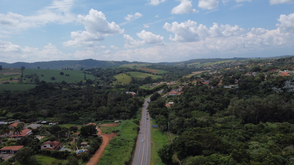 an aerial view of a road surrounded by trees