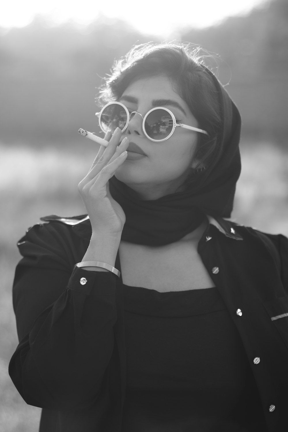 A woman in a hijab smoking a cigarette photo – Free Hamedan Image on  Unsplash