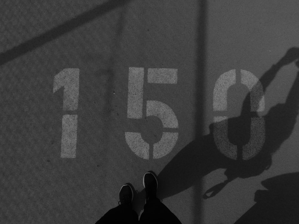 un'ombra di una persona in piedi su un campo da tennis