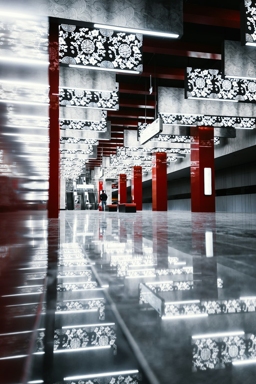 a black and white photo of a building with red pillars