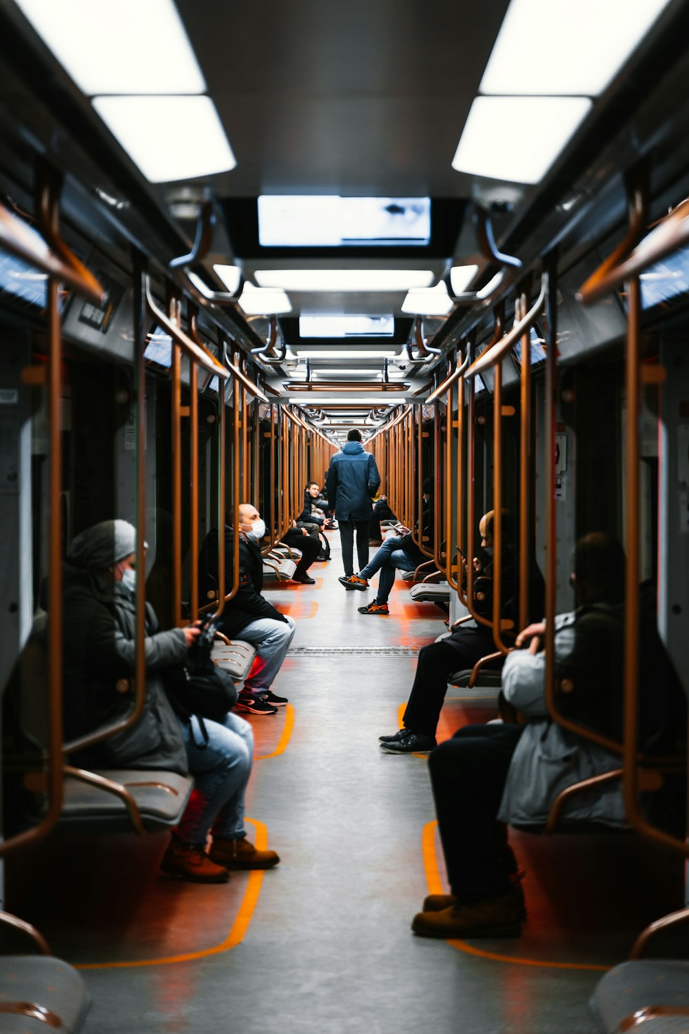 a group of people sitting on a train next to each other