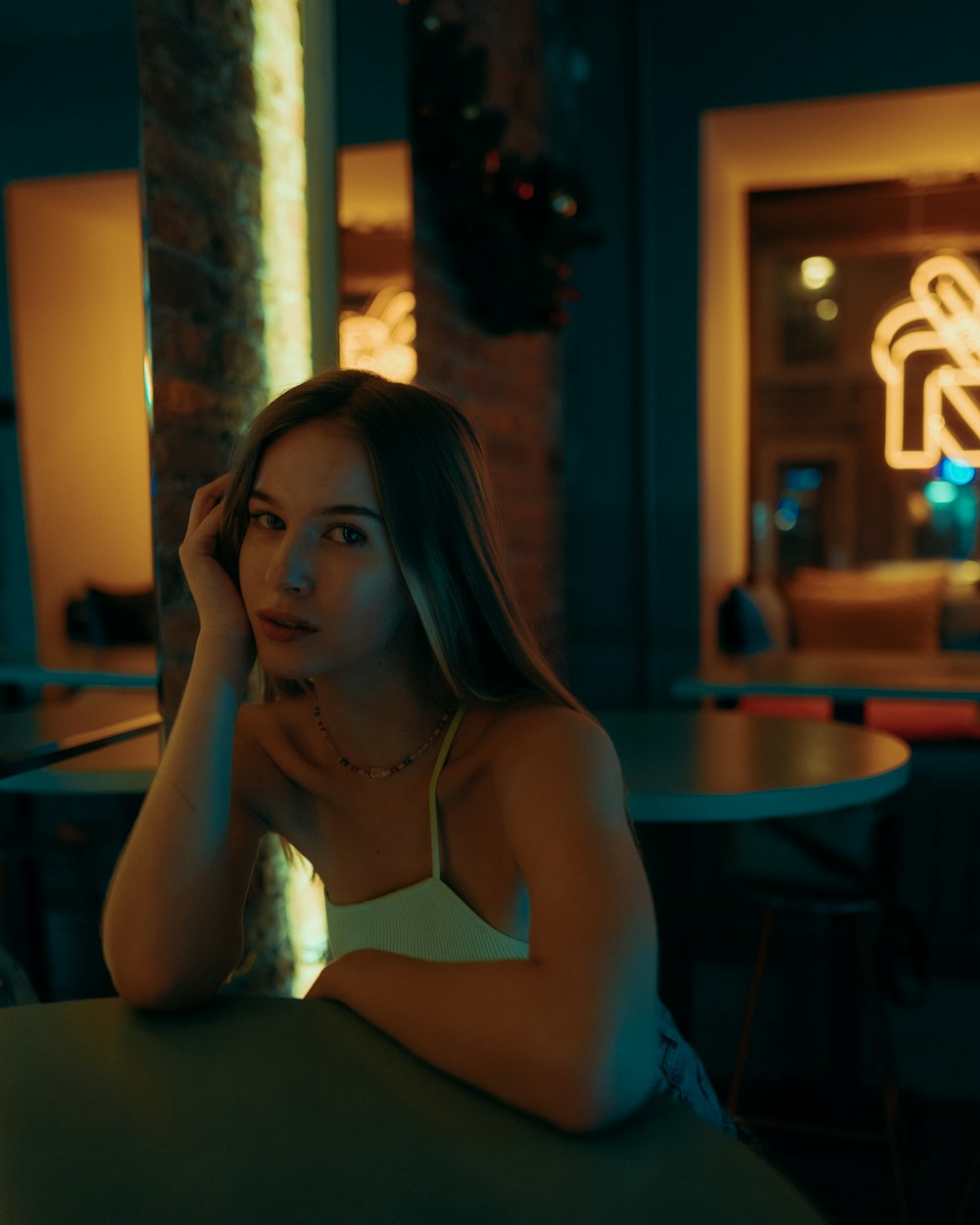 a woman sitting at a table in a restaurant