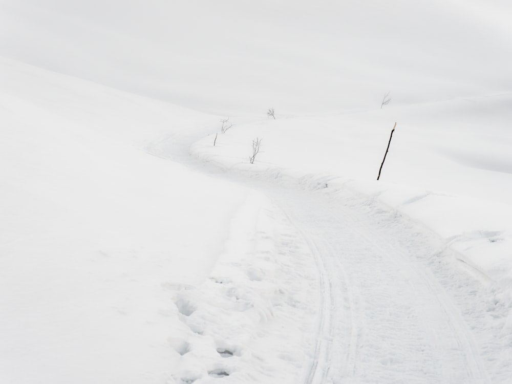 a person riding skis down a snow covered slope