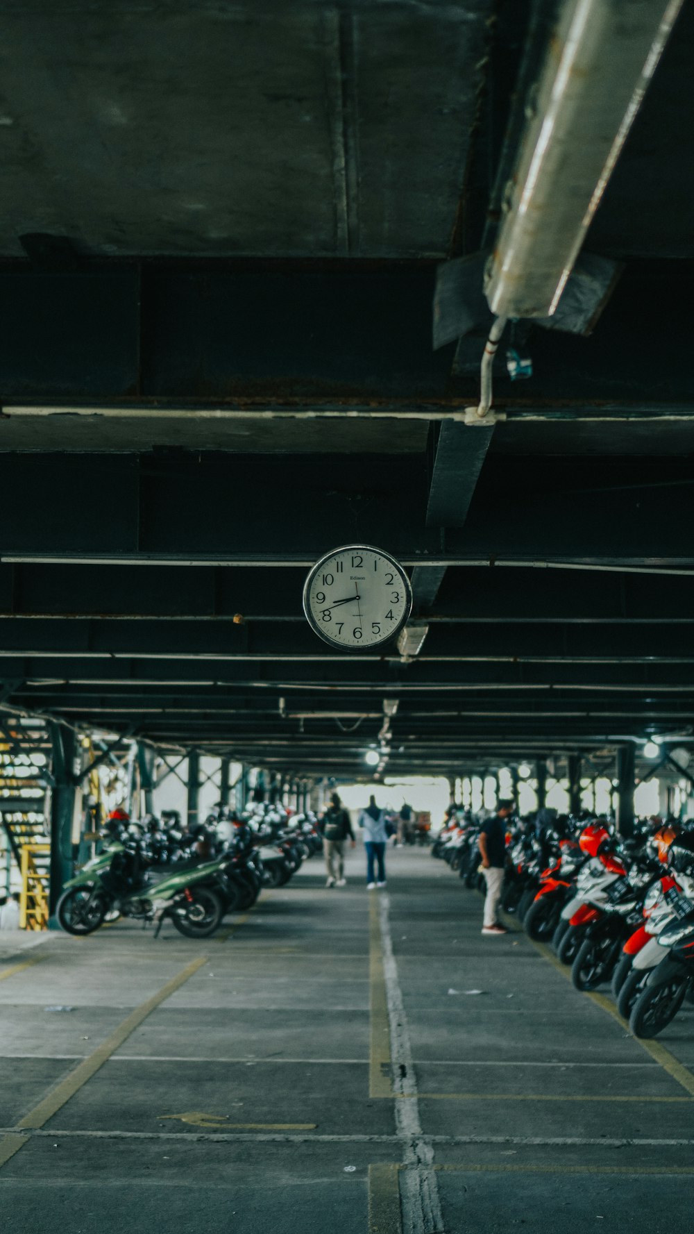 a group of motorcycles parked in a parking garage