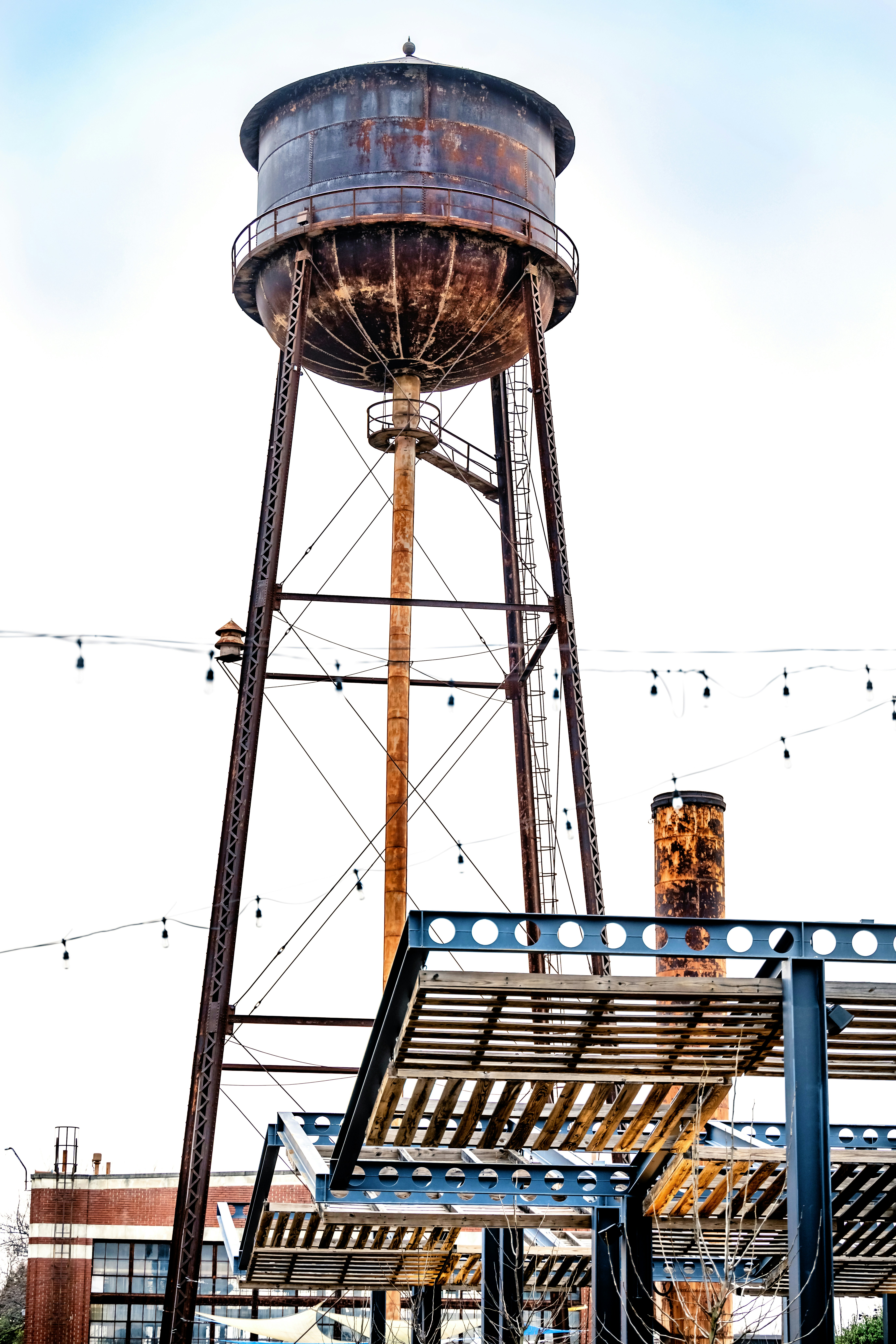 a large metal water tower next to a building