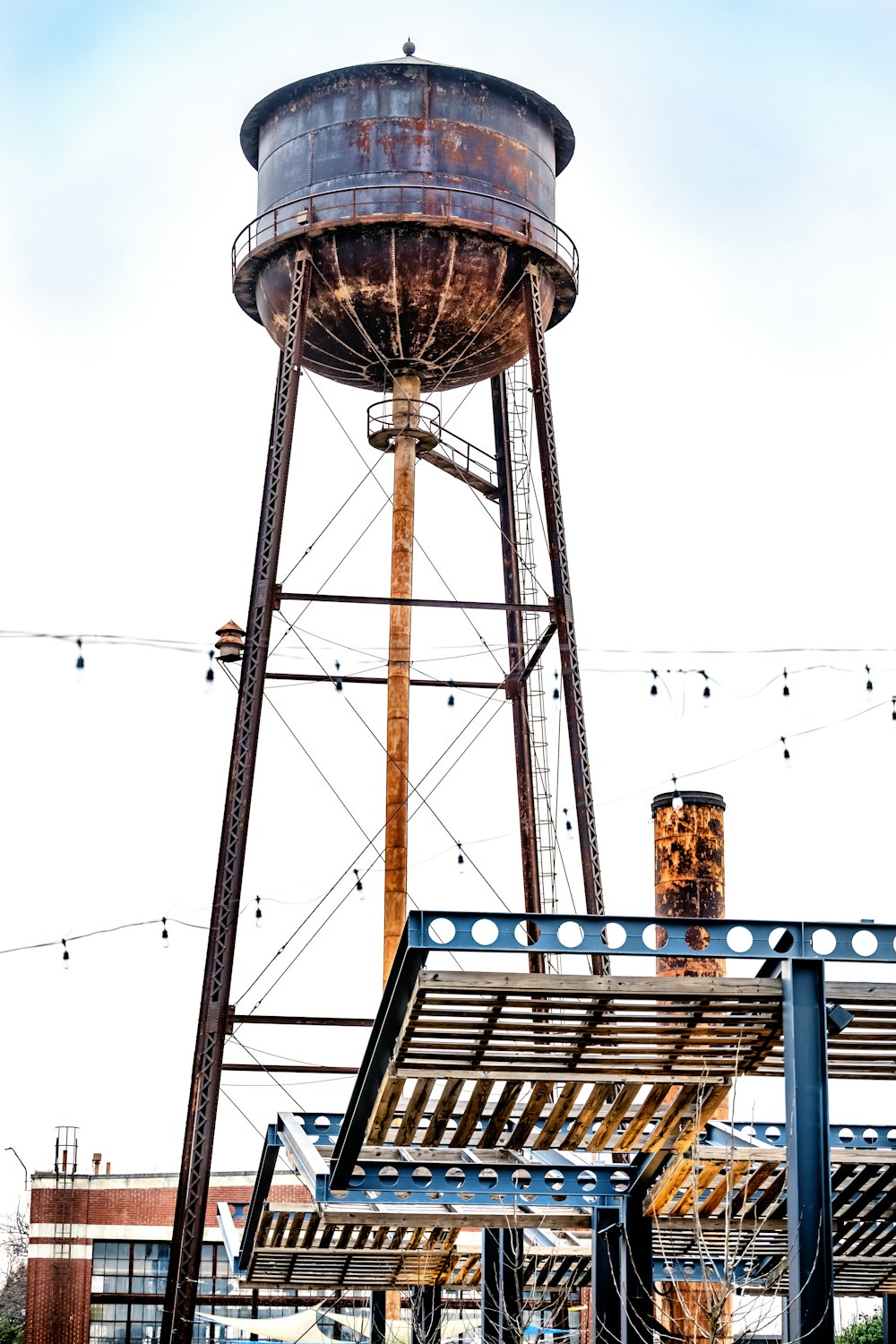 a large metal water tower next to a building