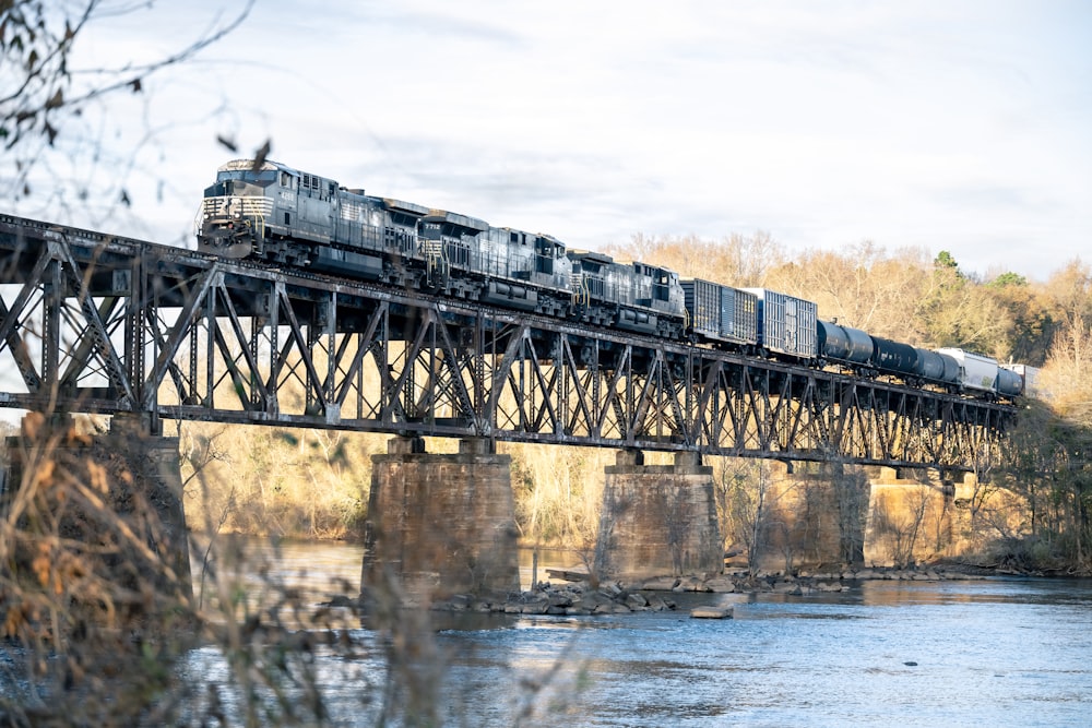 a train traveling over a bridge over a river