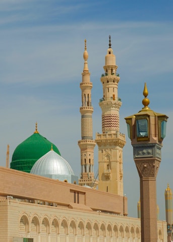 a large building with a green dome and a clock tower
