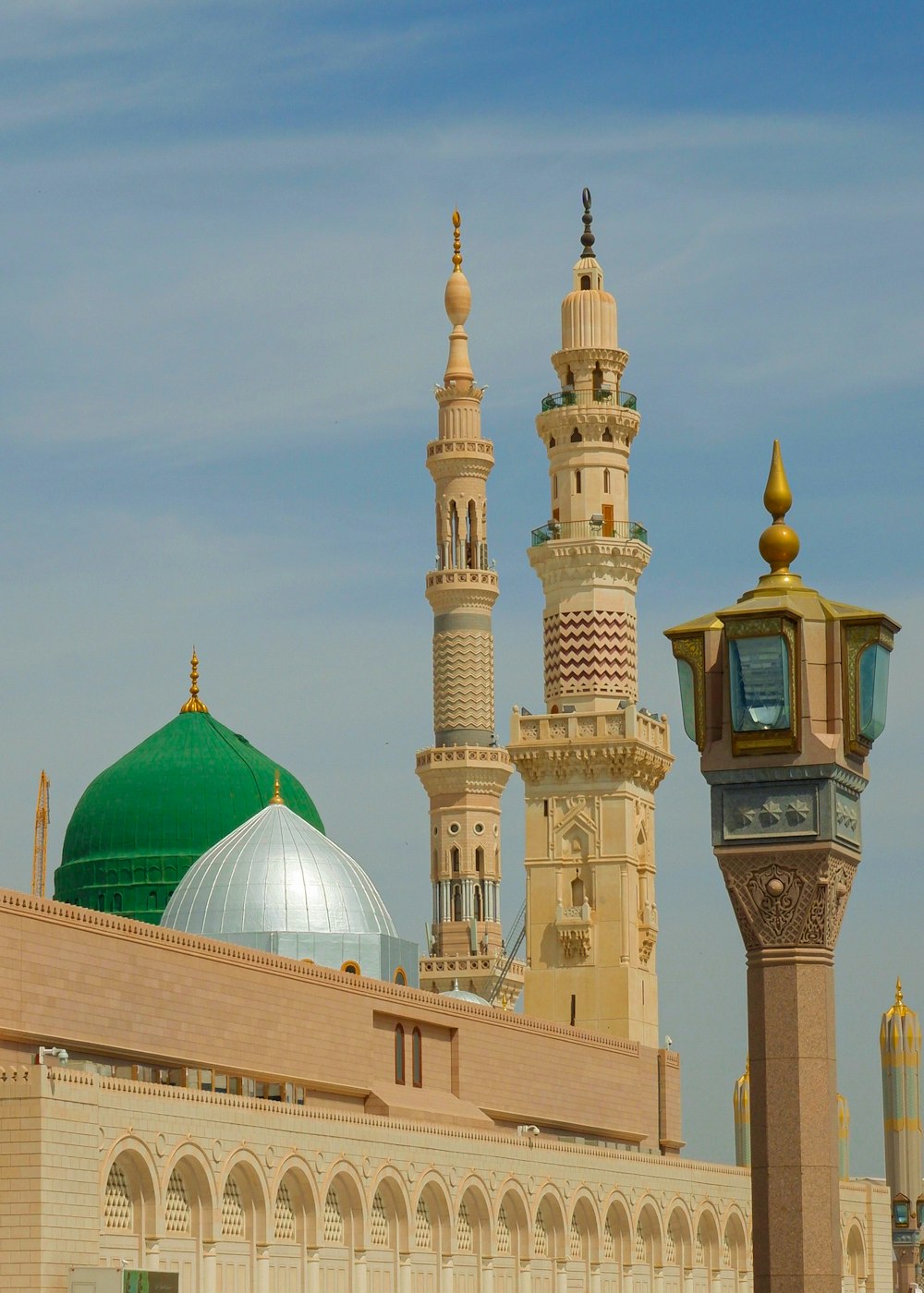 a large building with a green dome and a clock tower