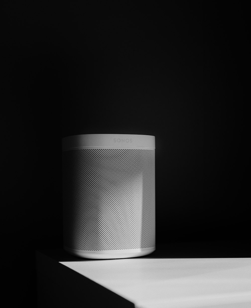 a white speaker sitting on top of a table