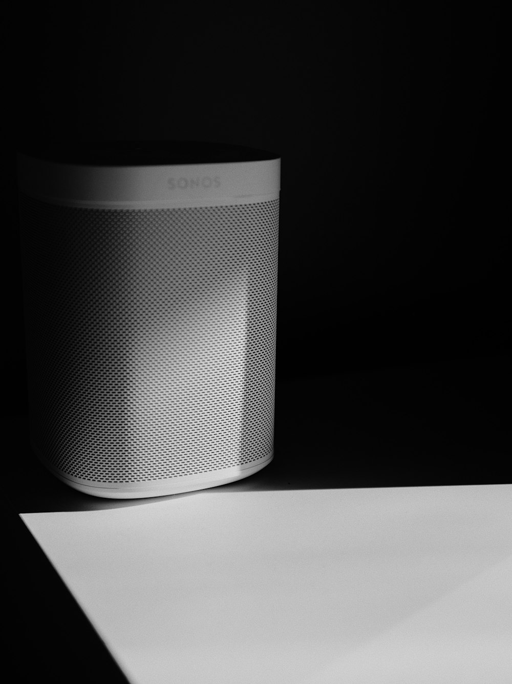a white speaker sitting on top of a table