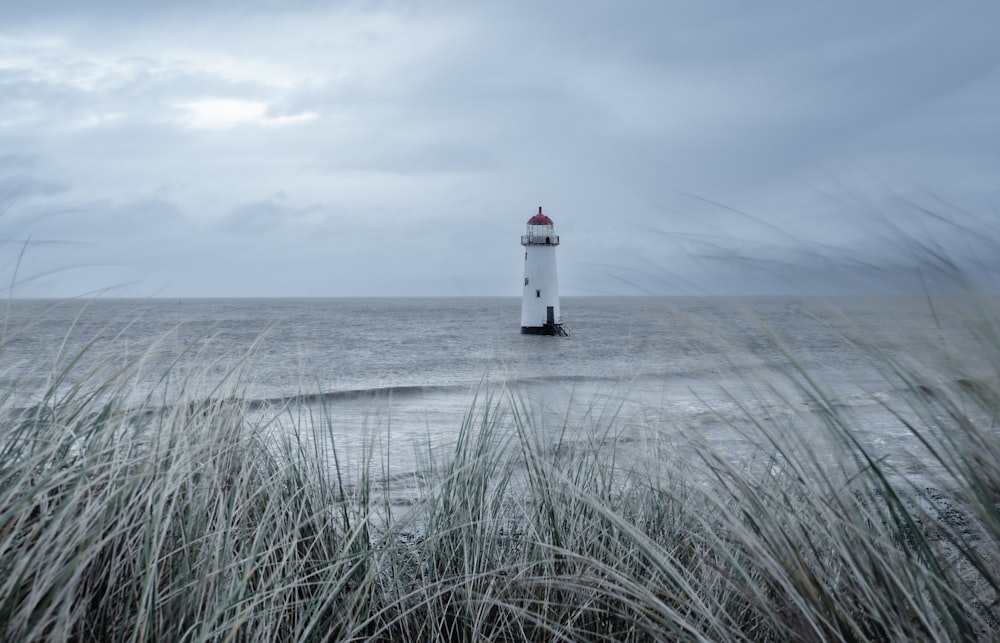 a light house in the middle of a body of water