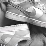 Close-up of authentic Nike sneakers with detailed stitching on a white background.