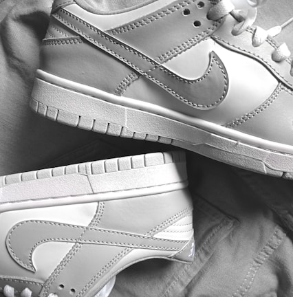 Close-up of authentic Nike sneakers with detailed stitching on a white background.