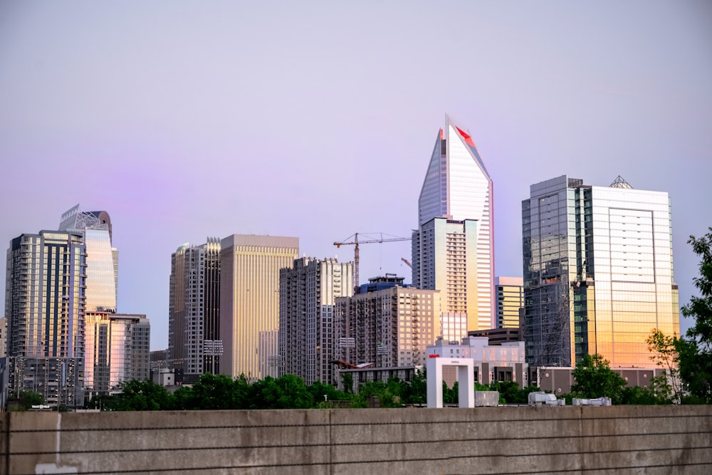 a city skyline with tall buildings in the background