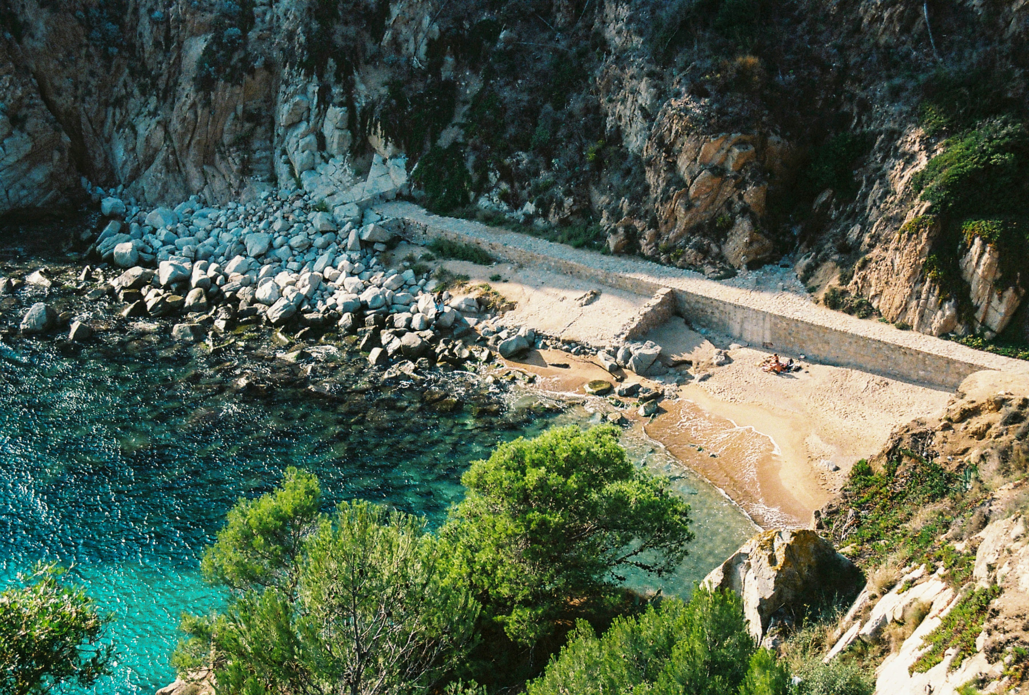 an aerial view of a rocky beach and a body of water